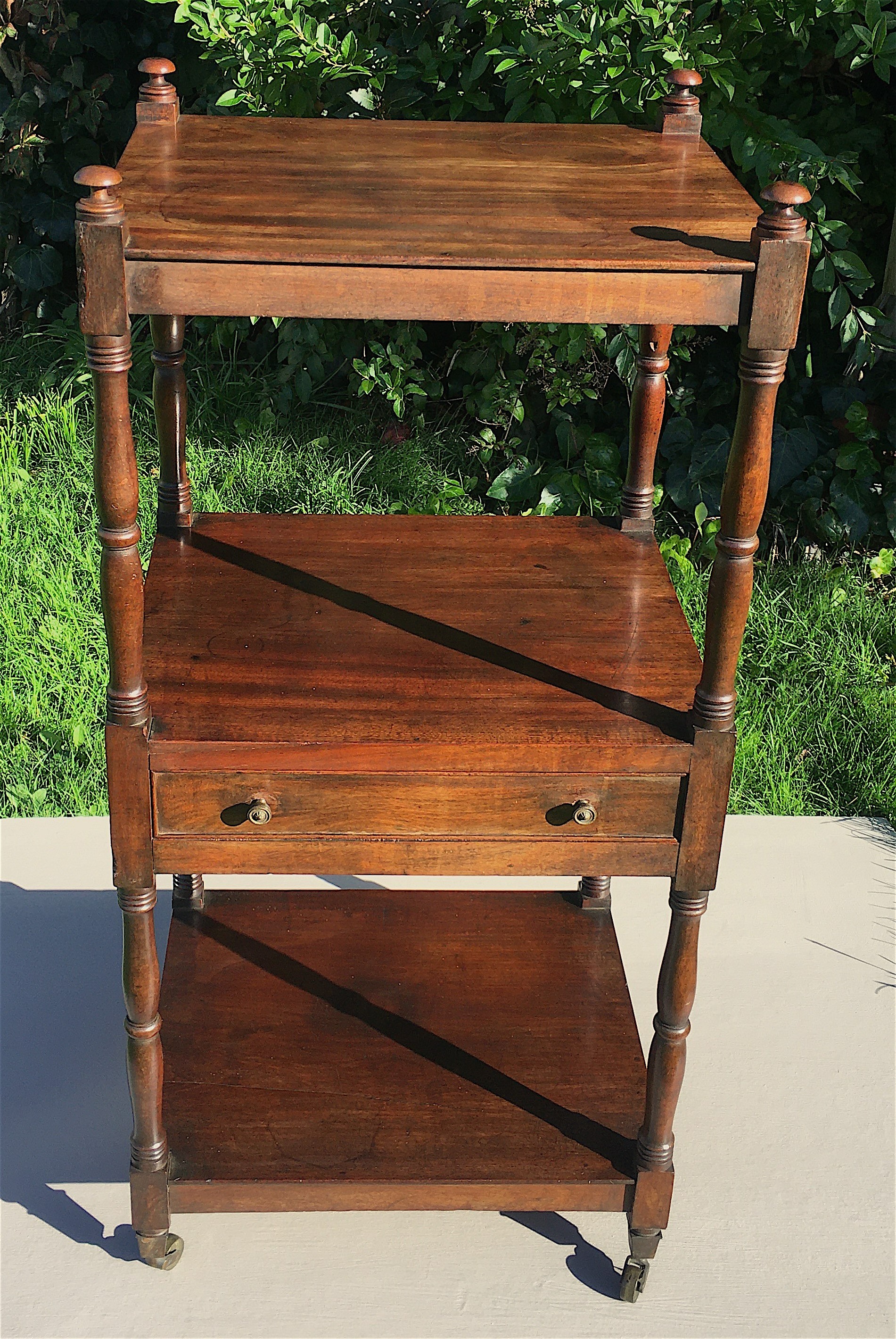 A Regency mahogany three tier whatnot fitted mid drawer, width 46cm, depth 38cm, height 98cm.